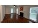 Bright living room boasts a decorative fireplace, hardwood floors, and large windows at 2716 Rea Rd, Charlotte, NC 28226