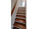 Hardwood staircase with white risers and handrail leads upstairs at 2716 Rea Rd, Charlotte, NC 28226