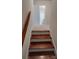 Hardwood staircase leads to a hallway with carpet and a bathroom at 2716 Rea Rd, Charlotte, NC 28226