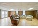 Finished basement with tile flooring, paneled walls, and ample seating, perfect for relaxation and entertainment at 2968 Grace St, Claremont, NC 28610
