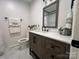 Bathroom with modern vanity, quartz countertops, and updated fixtures and gray and white color palette at 2968 Grace St, Claremont, NC 28610