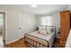 Bright bedroom boasts hardwood floors, a comfortable bed, and a serene atmosphere with plenty of natural light at 2968 Grace St, Claremont, NC 28610