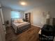 A serene bedroom with natural light, wood-look flooring, and minimalist decor at 2968 Grace St, Claremont, NC 28610