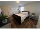 Cozy bedroom with comfortable bedding, neutral tones, and wood-look flooring at 2968 Grace St, Claremont, NC 28610