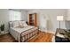 Cozy bedroom featuring hardwood floors, a decorative ladder, and a charming wrought-iron bed frame at 2968 Grace St, Claremont, NC 28610