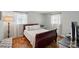 Bedroom with neutral paint, hardwood floors, and bright windows at 2968 Grace St, Claremont, NC 28610