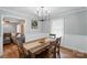 Bright dining room featuring wood floors, table with seating for four, and a decorative chandelier at 2968 Grace St, Claremont, NC 28610