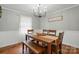 Cozy dining room with wood table, bench seating, and a modern chandelier at 2968 Grace St, Claremont, NC 28610