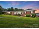 Charming brick home with manicured lawn, welcoming front porch, and patriotic American flag at 2968 Grace St, Claremont, NC 28610