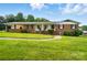 Classic brick home with a well-maintained lawn, inviting porch, and traditional American flag display at 2968 Grace St, Claremont, NC 28610