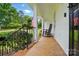 Relaxing front porch view with rocking chair, decorative cushions, and a glimpse of the lush front yard at 2968 Grace St, Claremont, NC 28610