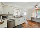 Bright kitchen featuring white cabinets, stainless steel appliances, and hardwood floors at 2968 Grace St, Claremont, NC 28610