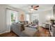 Comfortable living room with gray sectional sofa, wood floors, and view into the dining area at 2968 Grace St, Claremont, NC 28610