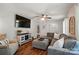 Bright living room with a comfy gray sectional, wood floors, and a large television at 2968 Grace St, Claremont, NC 28610