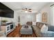 Spacious living room featuring a plush gray sectional, wood-style floors, and modern décor at 2968 Grace St, Claremont, NC 28610