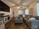 Comfortable living room with plush sectional, wood-look flooring, and ceiling fan at 2968 Grace St, Claremont, NC 28610