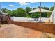 Backyard pool area with brick and white fence, promising summer fun and relaxation at 2968 Grace St, Claremont, NC 28610