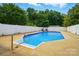 Refreshing in-ground pool surrounded by a concrete deck and secure fencing for summertime enjoyment and relaxation at 2968 Grace St, Claremont, NC 28610