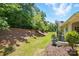 Serene backyard with mature trees, providing a private and peaceful outdoor space at 31415 Royal Tern Ln, Fort Mill, SC 29707