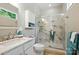 Bathroom with marble shower, vanity and sink, and bright lighting at 31415 Royal Tern Ln, Fort Mill, SC 29707