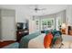 Bedroom with hardwood floors, ceiling fan, and large windows at 31415 Royal Tern Ln, Fort Mill, SC 29707