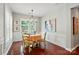 Dining room with wood floors, plantation shutters, and modern light fixture at 31415 Royal Tern Ln, Fort Mill, SC 29707