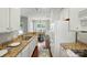 Bright, functional kitchen with granite countertops, white cabinets, and views to a dining area at 31415 Royal Tern Ln, Fort Mill, SC 29707