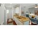 Functional kitchen with granite counters, white cabinetry, and a passthrough to the living room at 31415 Royal Tern Ln, Fort Mill, SC 29707