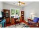 Inviting office space with wood floors, bookshelves, a ceiling fan, and a large window with shutters at 31415 Royal Tern Ln, Fort Mill, SC 29707