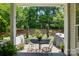 View of a charming outdoor patio with a table, chairs, and lush landscaping at 31415 Royal Tern Ln, Fort Mill, SC 29707