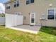Back patio of a home with a white fence, tan siding, and a grass lawn at 3306 Yarmouth Ln, Gastonia, NC 28056