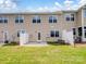 Townhome backyard featuring a small patio, a grassy lawn and a partial privacy fence at 3306 Yarmouth Ln, Gastonia, NC 28056