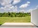 Backyard view highlighting a large grassy area, bordered by a white fence, with partial views of neighborhood at 3306 Yarmouth Ln, Gastonia, NC 28056