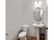 Cozy half bath with pedestal sink, oval mirror, and neutral walls at 3306 Yarmouth Ln, Gastonia, NC 28056