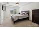 Bedroom with plush carpeting, large window, and tray ceiling at 3306 Yarmouth Ln, Gastonia, NC 28056