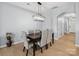The dining room boasts modern light fixture, beautiful wood floors, and neutral paint perfect for entertaining guests at 3306 Yarmouth Ln, Gastonia, NC 28056