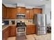 This kitchen features stainless appliances, granite countertops and plentiful wood cabinets with a wood backsplash at 3306 Yarmouth Ln, Gastonia, NC 28056