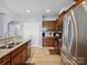 Kitchen area featuring a stainless dishwasher and sink, stainless appliances, with granite countertops and wood cabinets at 3306 Yarmouth Ln, Gastonia, NC 28056