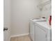 A small laundry room with a washer, dryer, and wire shelving at 3306 Yarmouth Ln, Gastonia, NC 28056