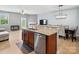 Open layout featuring a kitchen bar with views of the dining room and living area with fireplace at 3306 Yarmouth Ln, Gastonia, NC 28056