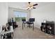 Bright office space featuring neutral walls, carpet, ceiling fan, and a large window offering natural light at 3306 Yarmouth Ln, Gastonia, NC 28056