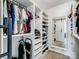 Organized walk-in closet with shelving, hanging racks, and full length mirror at 3306 Yarmouth Ln, Gastonia, NC 28056