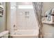 Clean bathroom with a tiled shower and bath featuring a built-in niche and towel rack at 3315 Whispering Creek Dr # 95, Wesley Chapel, NC 28079