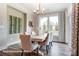 Modern dining room with large window, statement lighting, and seating for six at 3315 Whispering Creek Dr # 95, Wesley Chapel, NC 28079