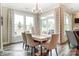 Bright dining room with large windows and seating for six, open to the living area at 3315 Whispering Creek Dr # 95, Wesley Chapel, NC 28079