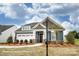 Charming single-Gathering home with blue siding, stone accents, and a well-manicured front lawn at 3315 Whispering Creek Dr # 95, Wesley Chapel, NC 28079