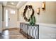 Inviting hallway with hardwood floors, decorative mirror, and stylish console table at 3315 Whispering Creek Dr # 95, Wesley Chapel, NC 28079