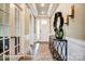 Inviting hallway with hardwood floors, decorative mirror, and stylish console table at 3315 Whispering Creek Dr # 95, Wesley Chapel, NC 28079