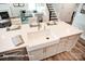 Bright kitchen with white island, farmhouse sink, and seating, open to living area at 3315 Whispering Creek Dr # 95, Wesley Chapel, NC 28079