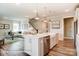 Kitchen island featuring a stainless steel dishwasher and sink, with living area in view at 3315 Whispering Creek Dr # 95, Wesley Chapel, NC 28079